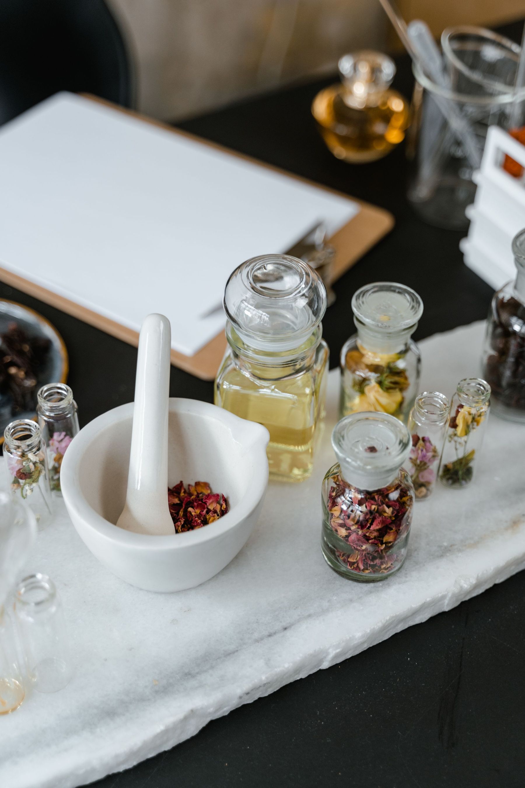 A perfumer’s workbench with jars and a mortar